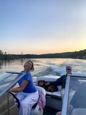 Kristen on boat with Tucker and her dad